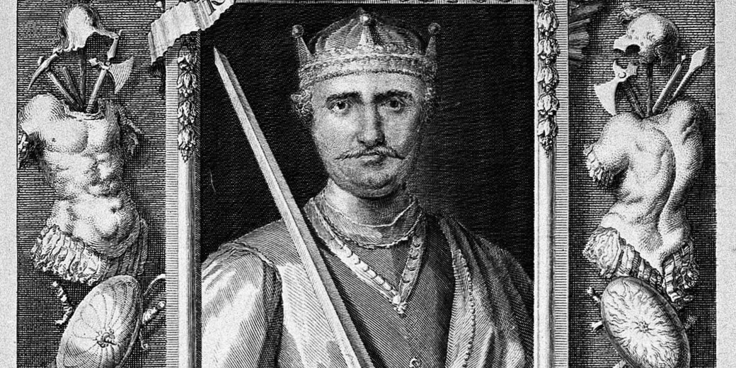 Black and white engraving of a crowned king holding a sword, framed by armor and weapons on either side.