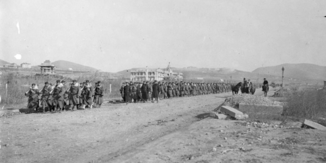 Japanese troops enter Port Arthur after the siege, directly matching the source material on Port Arthur and Manchuria.