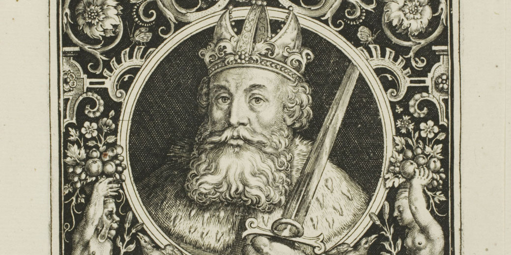 Engraving of Charlemagne in armor and crown, holding a sword, framed by decorative scrollwork.