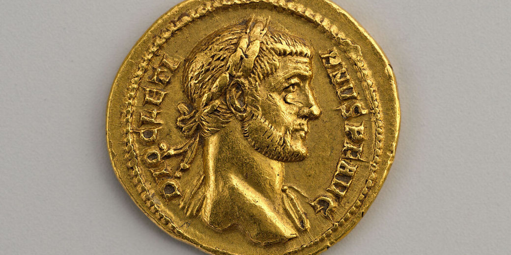 Roman gold coin featuring Emperor Diocletian's bust on the obverse and Jupiter holding a thunderbolt and sceptre on the reverse.