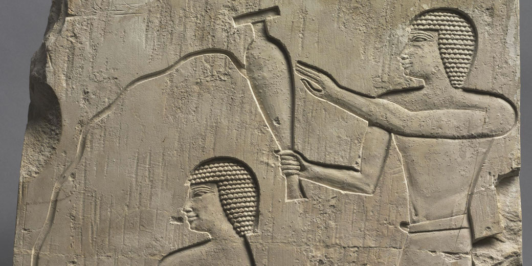 Limestone relief depicting an attendant pouring a libation for the deceased, reflecting Old Kingdom stylistic influences.