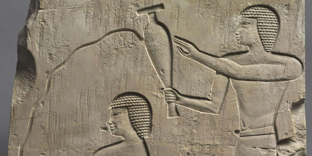 Limestone relief depicting an attendant pouring a libation for the deceased, reflecting Old Kingdom stylistic influences.