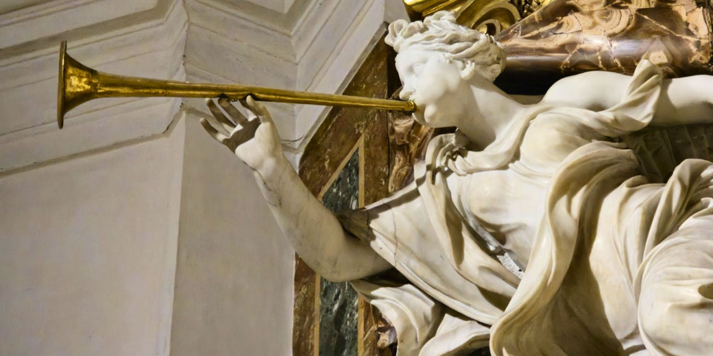 Marble sculpture of a winged female figure blowing a golden trumpet, captured in dynamic motion against a stone backdrop.