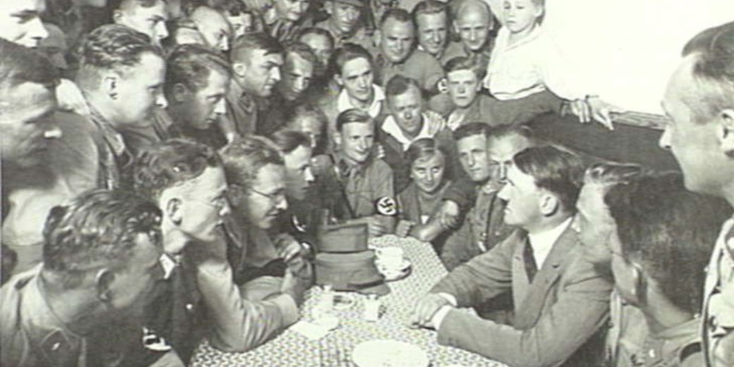 Adolf Hitler discussing politics with members of the National Socialist Workers