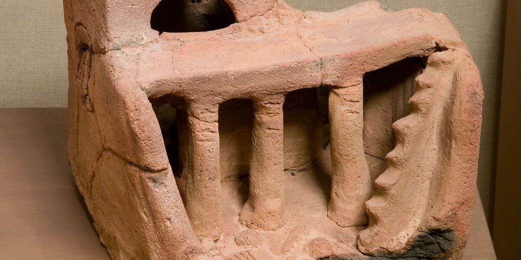 Pottery house model found in a tomb, useful for showing how artefacts can reveal burial customs and daily life.