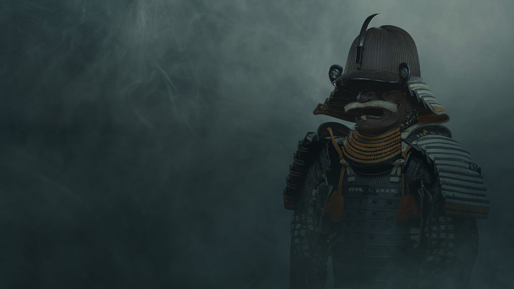 A samurai warrior in traditional armor stands in a misty, dark atmosphere. His menacing helmet features a mustached mask, ornate shoulder guards, and intricate rope detailing.