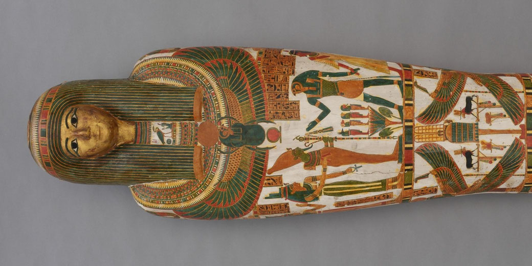 Painted wooden coffin containing a wrapped mummy, decorated with Egyptian deities, hieroglyphs, and patterned bands in rich colors reflecting burial customs of the Late Period.