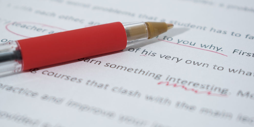 Red pen marking student essay