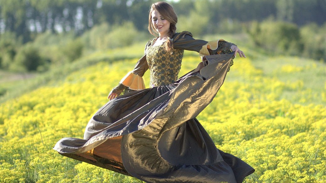 Medieval princess dancing in a field