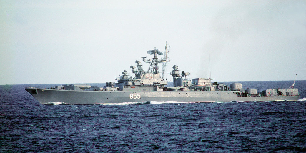 A gray military warship numbered 955 sails across open water, equipped with radar systems and various deck-mounted weapons.