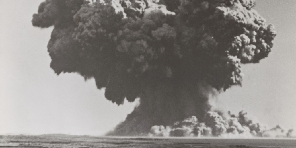 1952 photo captures Britain's first atomic bomb test at Monte Bello Islands, showing a massive plume of smoke and water.