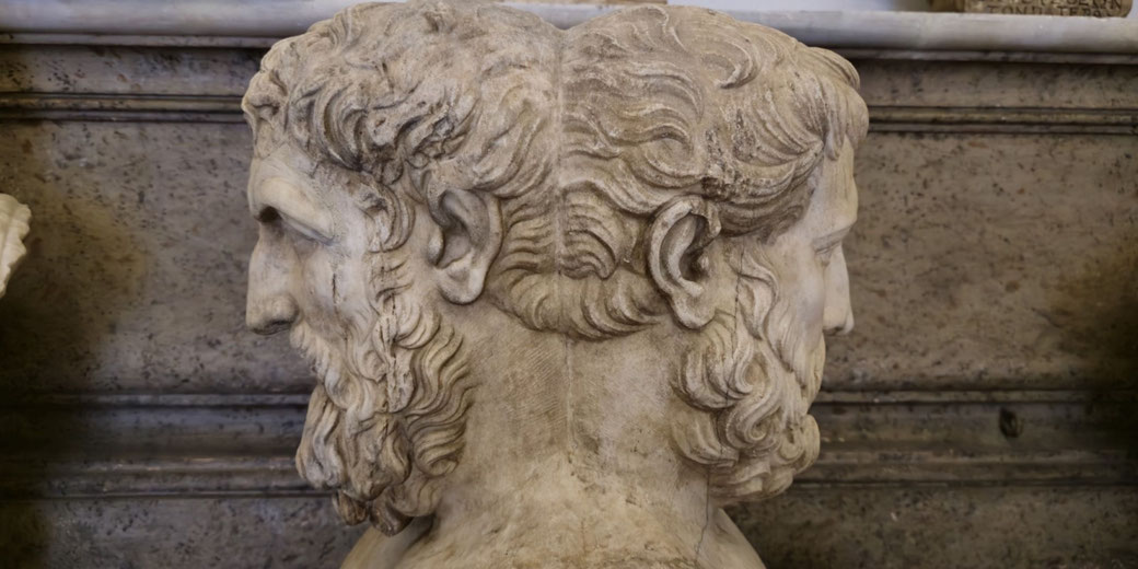 Marble bust with two bearded male heads facing opposite directions, symbolizing duality or transitions, likely representing the Roman god Janus.
