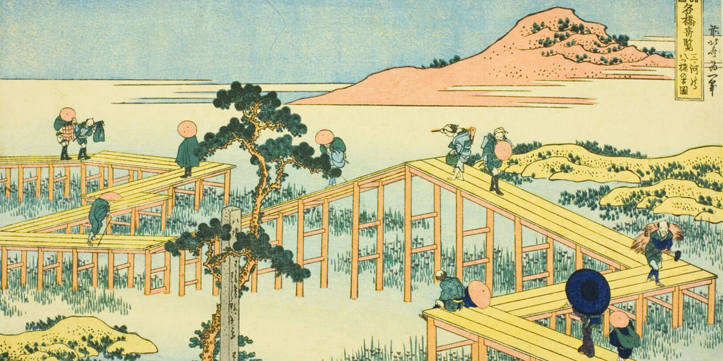A traditional Japanese ukiyo-e print depicts travelers crossing a zigzagging wooden bridge over a marsh, with a distant mountain and sky in the background.