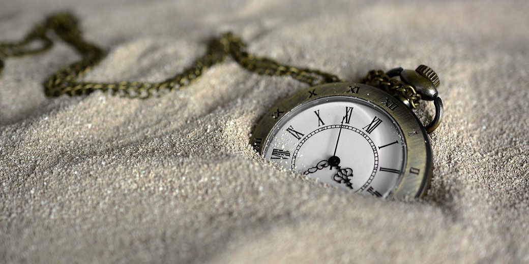 Pocket watch in sand