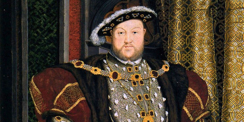A portrait of a bearded man in elaborate royal attire, wearing a feathered hat and gold-embroidered clothing.