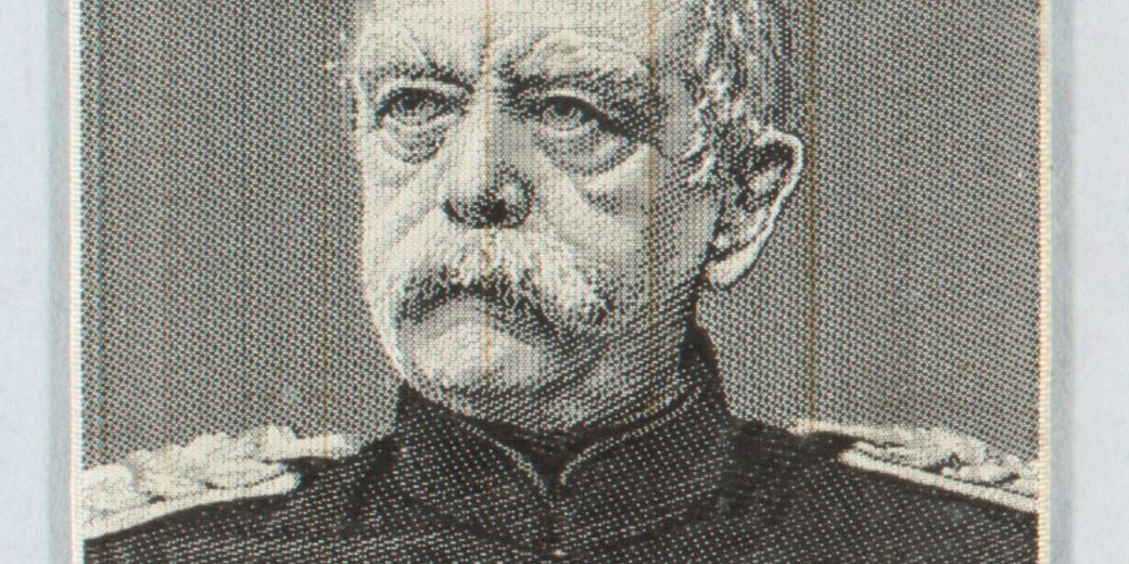 A detailed close-up of a monochrome engraved portrait of an older man with a mustache in military uniform.