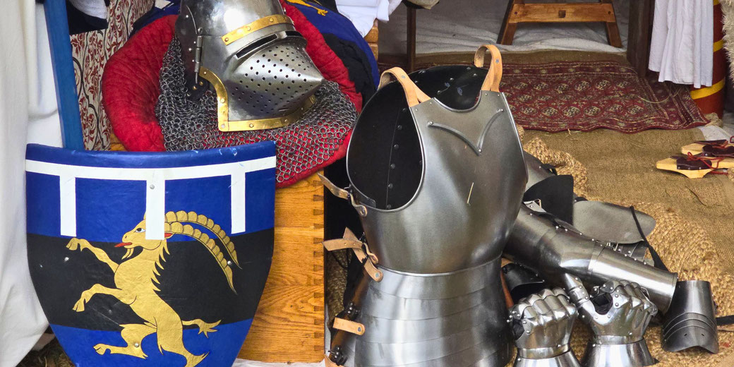 A medieval knight’s armor set, including a helmet, breastplate, gauntlets, and greaves.