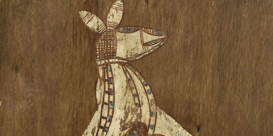 A traditional Aboriginal bark painting depicts a stylized animal, possibly a kangaroo, using natural pigments and intricate patterns on a wooden background.