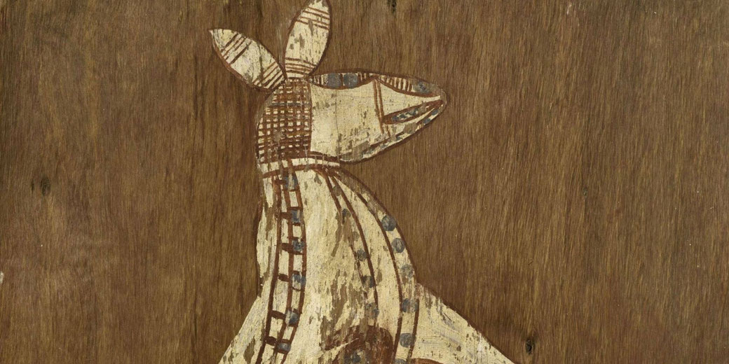 A traditional Aboriginal bark painting depicts a stylized animal, possibly a kangaroo, using natural pigments and intricate patterns on a wooden background.