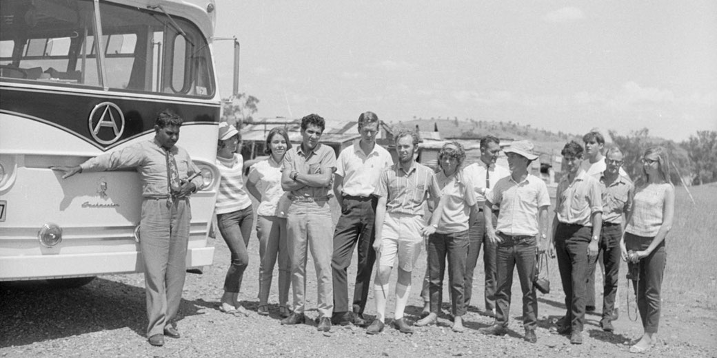 SAFA protesters standing alongside bus [Left to right:] Gerry Mason, Pat Healy, Sue Reeves, Charles Perkins, Ray Leppik, Bob Gallagher, Ann Curthoys, John Butterworth, Norm McKay, Alan Outhred, [unidentified], Colin Bradford, Louise Higham.