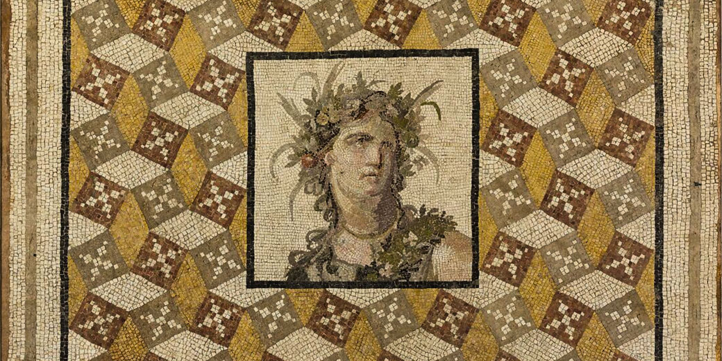 Ancient Roman mosaic featuring a central portrait of a crowned figure, surrounded by geometric patterns in earth tones.