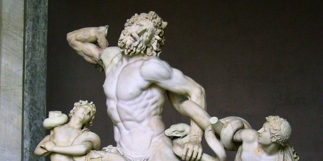Dramatic marble sculpture of Laocoön and his sons struggling against attacking serpents, showcasing intense emotion and movement.