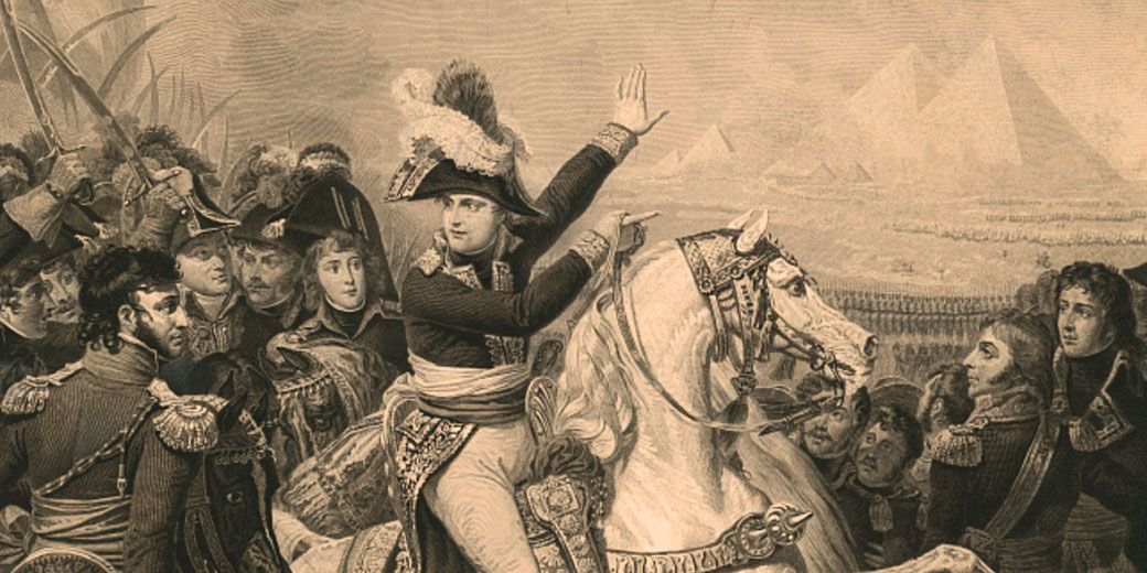 Napoleon, on horseback, gestures toward the pyramids while surrounded by soldiers, highlighting a key moment from his Egyptian campaign.