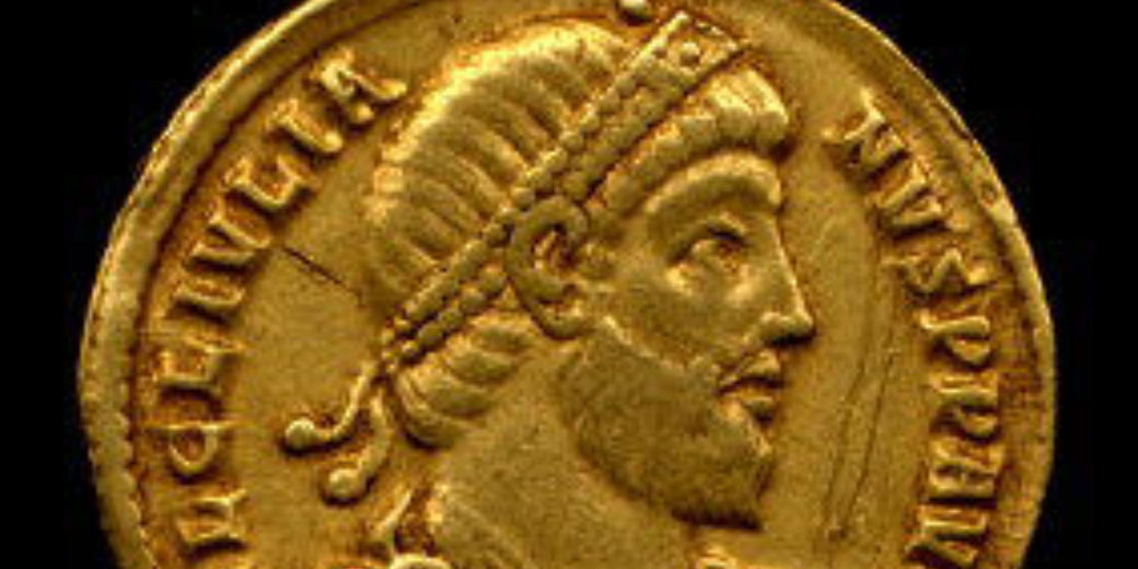 A gold solidus coin minted in Constantinople bearing the portrait of Emperor Julian “the Apostate” with Greek inscriptions; measures 2 × 0.1 cm.