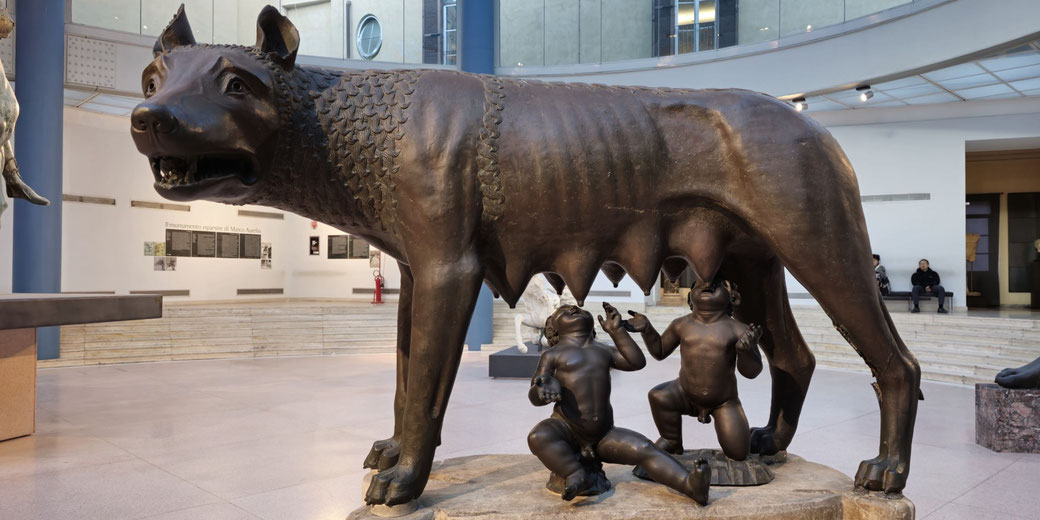 Bronze statue of a she-wolf suckling two human infants, representing the legend of Romulus and Remus, founders of Rome.