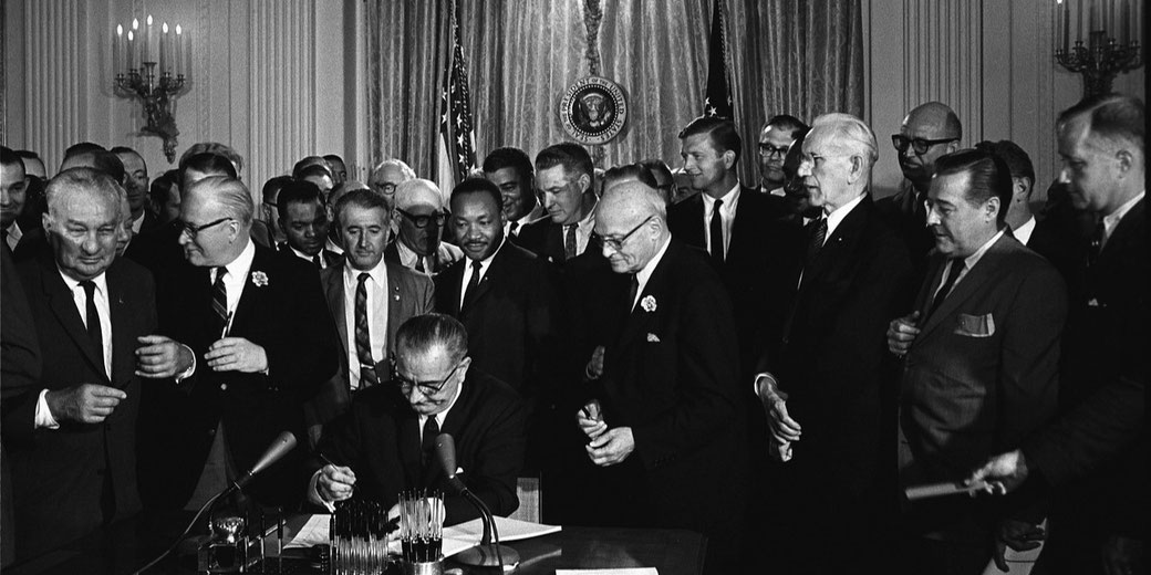 President Johnson signing with 1964 Voting Rights Act with Martin Luther King