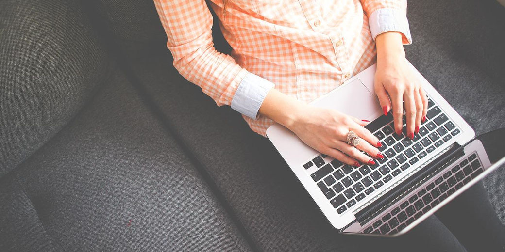 Woman typing on a laptop