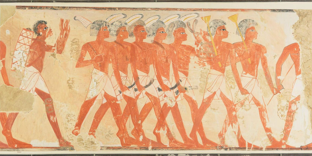 Painted scene of musicians in profile, showing Nubian and Egyptian figures with instruments, differentiated by dress and features, arranged in a horizontal procession.