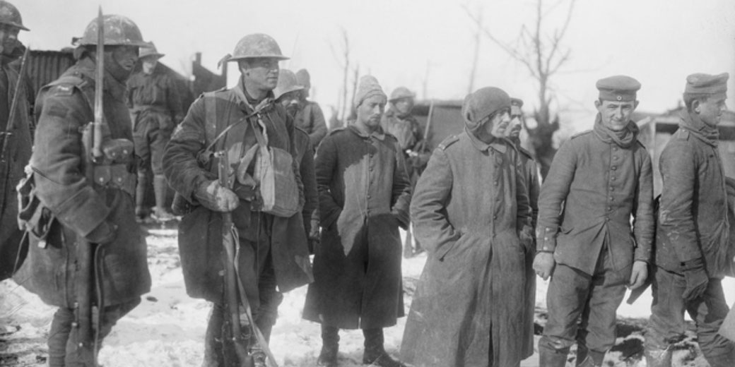 Australians guarding German prisoners captured at Stormy Trench, near Bazentin, in February 1917.