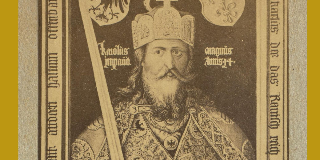 Black-and-white photograph of Albrecht Dürer’s painting showing Emperor Charlemagne standing frontally, holding a sword and an orb topped with a cross, wearing a crown and richly patterned imperial garments.