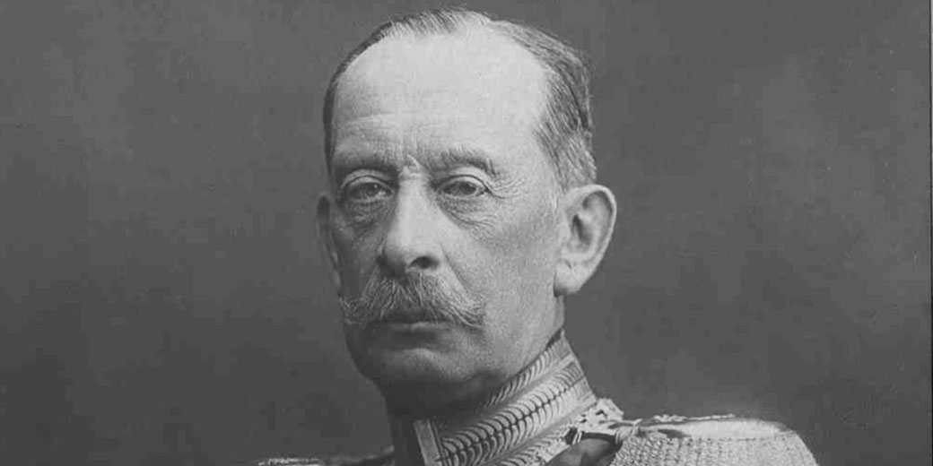 Black-and-white portrait of an older man with a mustache in a decorated military uniform, facing the camera with a serious expression.