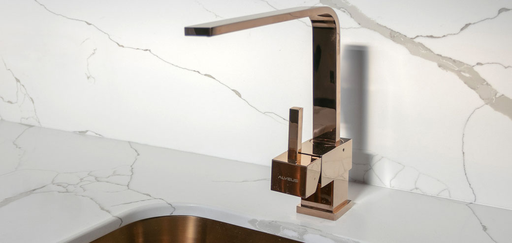 Engineered quartz countertop and protective wall in the kitchen