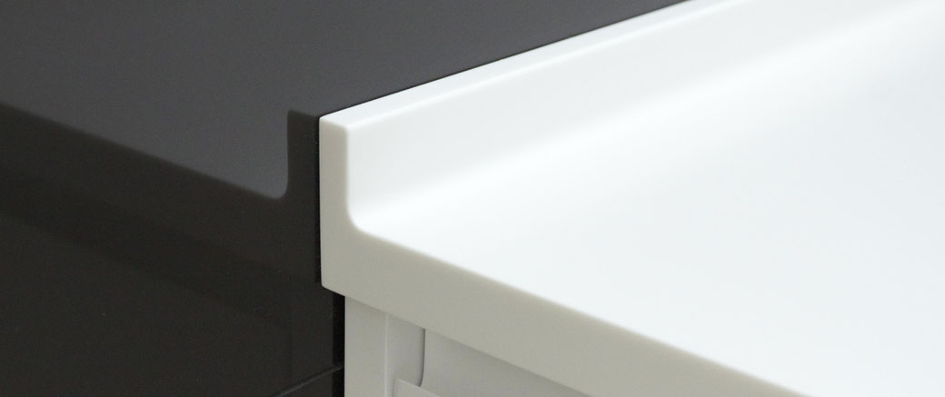 Solid surface bathroom vanity with an elevated edge from water droplets can be joined seamlessly