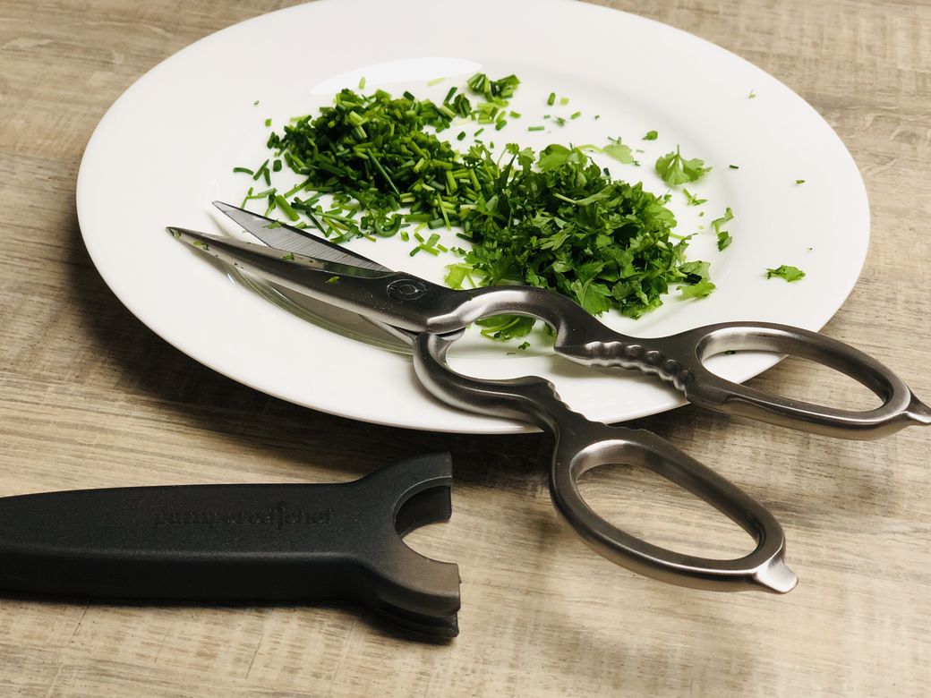 Die Schere von Pampered Chef ist aus Edelstahl und ist perfekt für das Schneiden von Hühnerknochen, das Trimmen von Fleisch, das Schneiden von Kräutern und vielem mehr. Für eine einfache Reinigung können die Klingen auseinandergenommen werden.