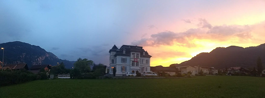 Adventure hostel Interlaken with the sun setting behind the Niederhorn