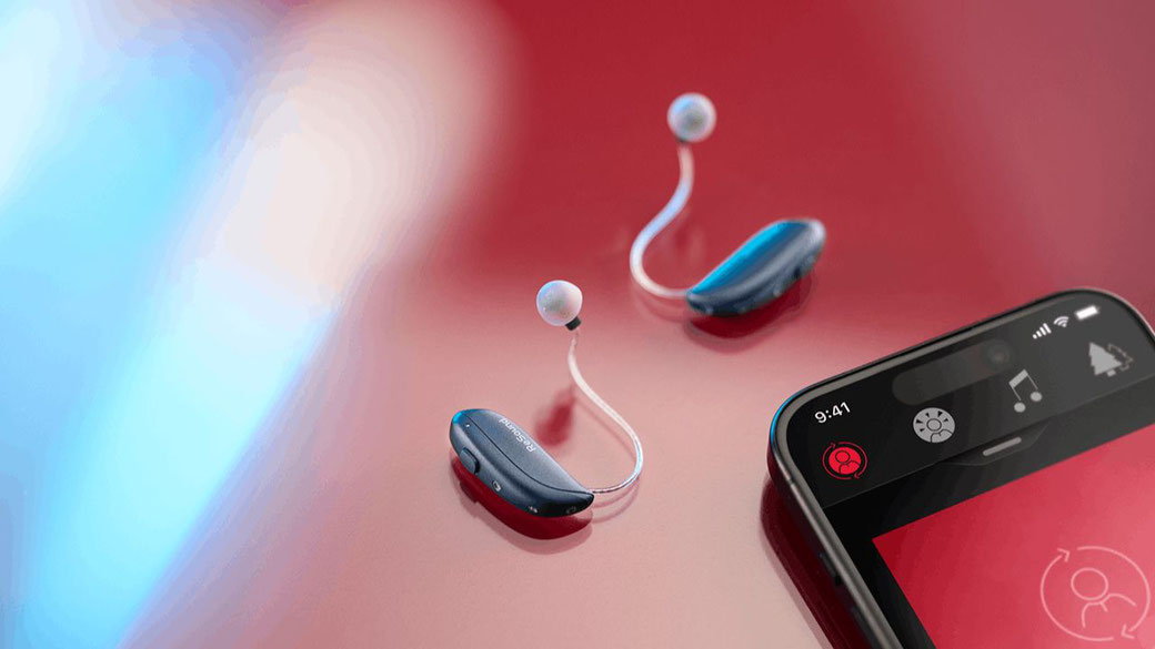 Pair of ReSound Vivia next to a phone with the Smart 3D app