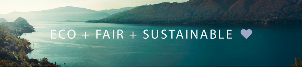 Text Eco + Fair + Sustainable mit Landschaftshintergrund