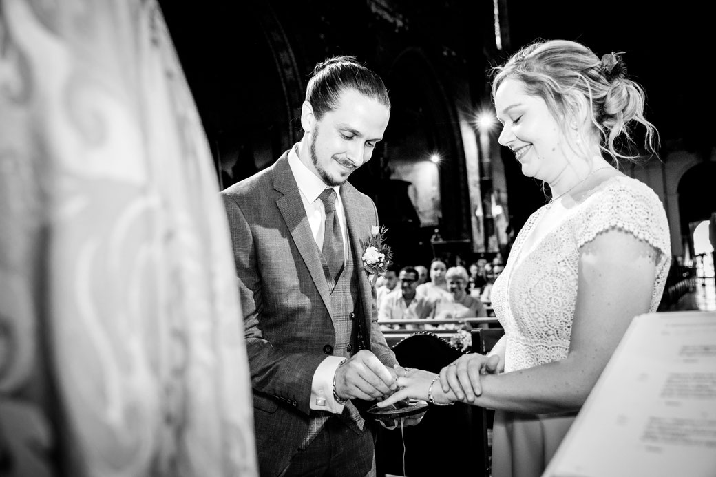 Échange des alliances pendant une cérémonie de mariage photographiée en noir et blanc par un photographe de mariage à Montauban