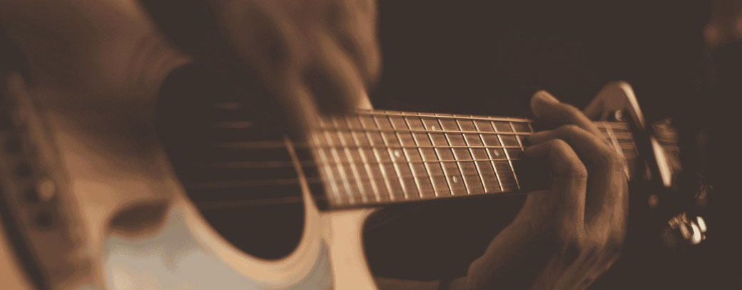 Close Up von Gitarrensaiten, die gespielt werden