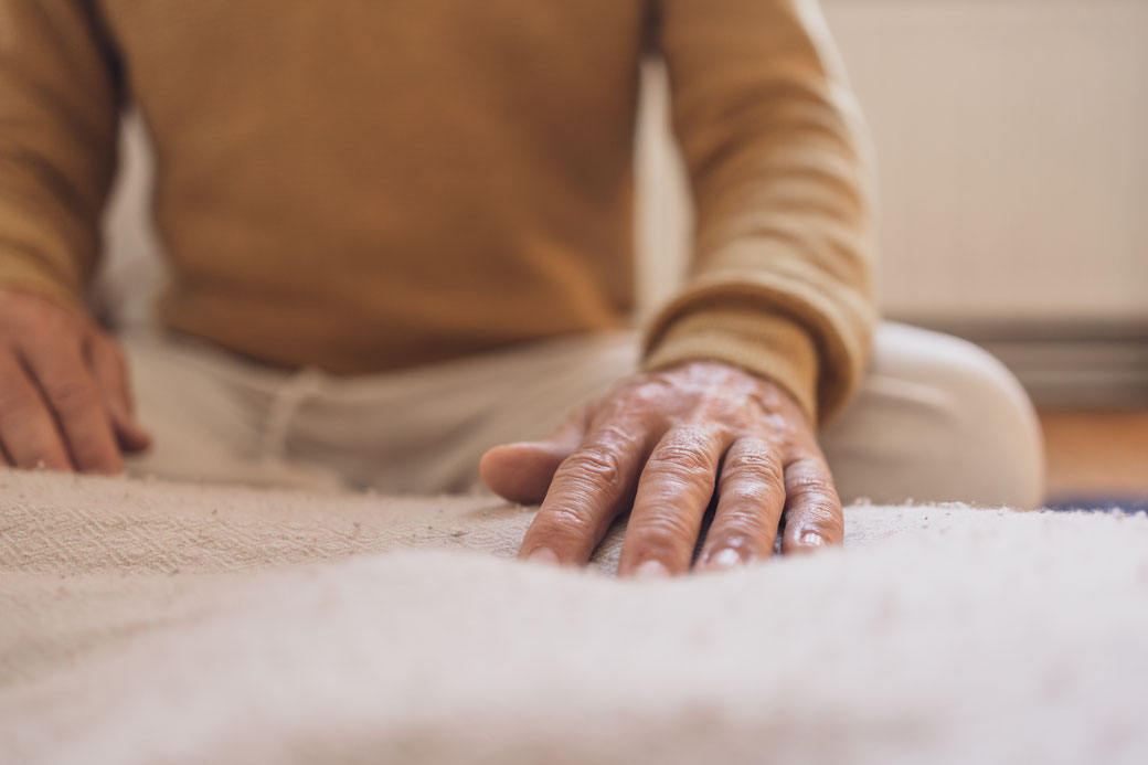Hände auf einer Decke bei der Behandlung eines Klienten