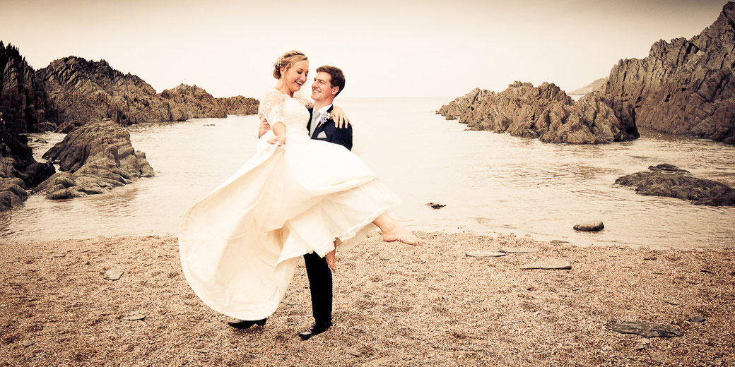 bride and groom on the woolacombe beach in natural portrait North Devon