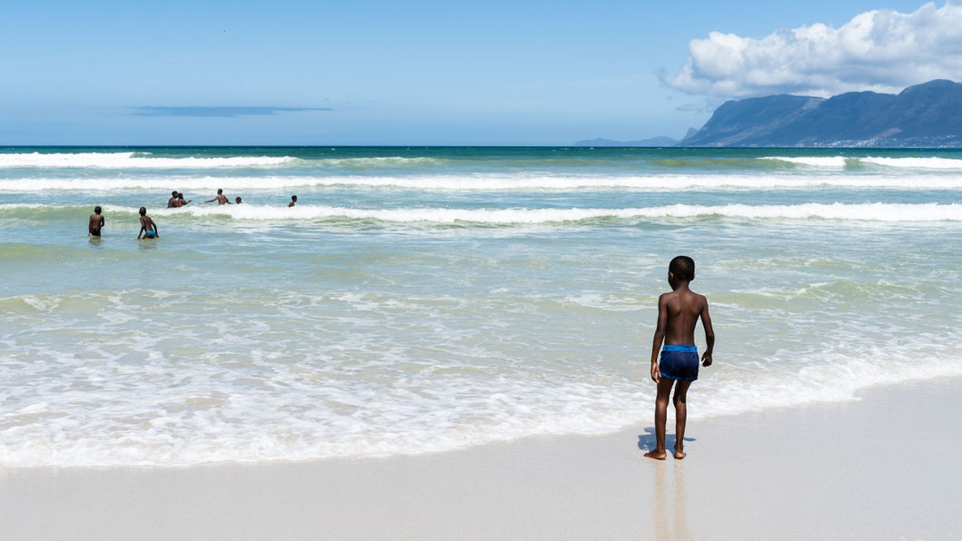 Children playing at the shore of the False Bay in Muizenberg