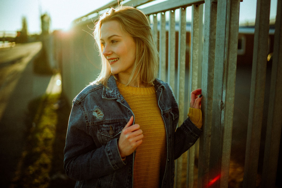 Junge Frau mit Jeansjacke lächelt