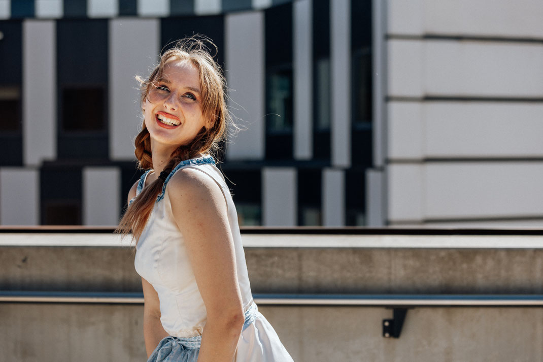 Eine Braut, wie sie in urbaner Umgebung in der Pfalz vor der Hochzeitsfotografin posiert.