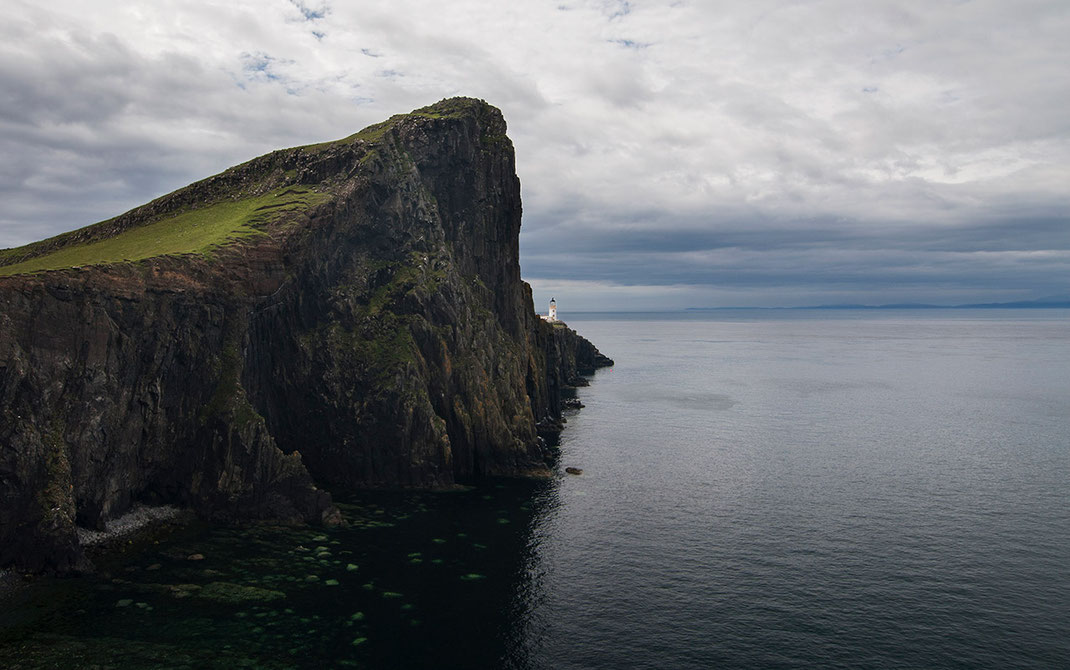 Neist Point Lighthouse on a cliff with ocean, Isle of Skye, Scotland, wide angle picture, 1280x802px