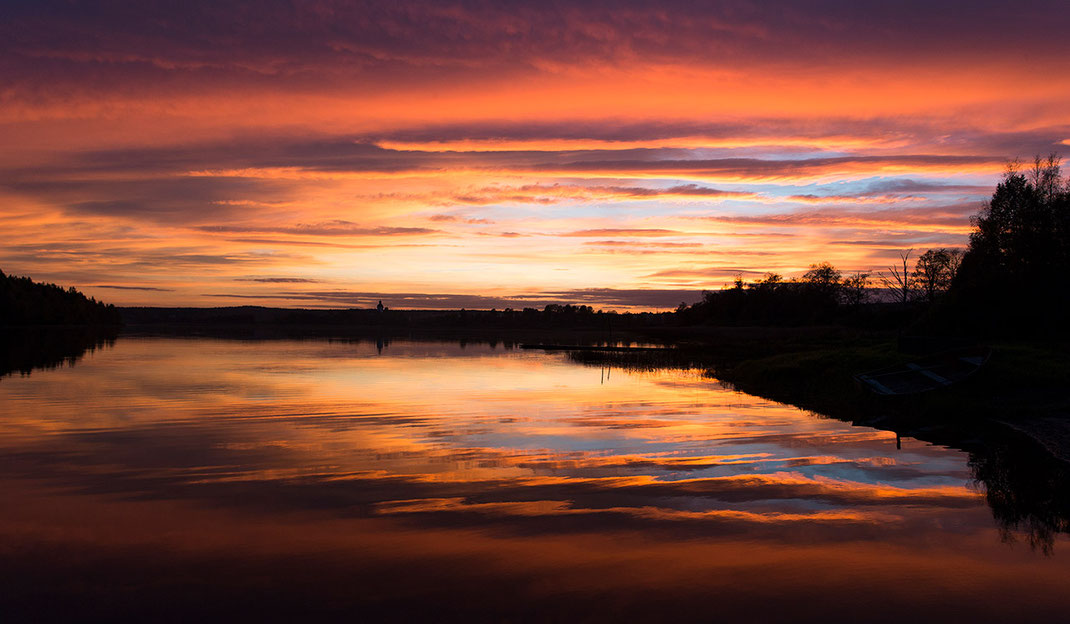 Amazing and unique Red, Orange sunset with reflections at a lake, Hundiksvall, Sweden, Scandinavia